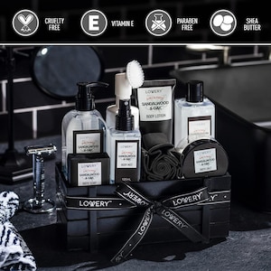 May include: A black wooden crate filled with bath and body products. The products include bottles, a bar of soap, and a jar, all labeled "Sandalwood & Oak" by LOVERY. A black ribbon with the LOVERY logo is tied around the crate. The image also includes a razor and a washcloth.
