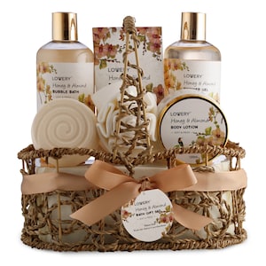 May include: A wicker basket filled with a honey and almond bath gift set. The set includes bubble bath, shower gel, body lotion, and bath salts. The basket is tied with a brown ribbon.
