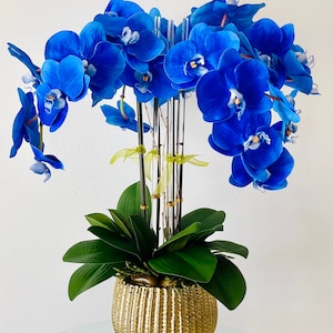 Blue Orchids Centerpiece in a Gold or Silver vase by White Touch Design.