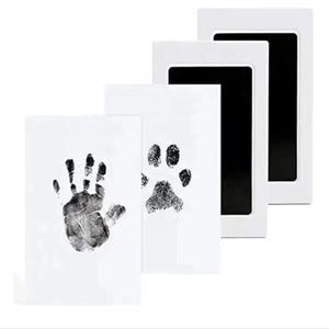 May include: Three white ink pads with black ink wells. The ink pads are for making handprints and paw prints.