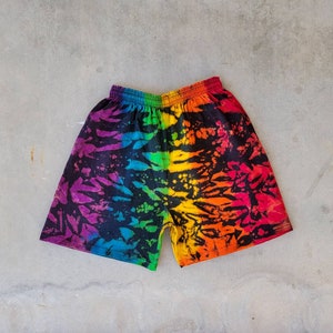 May include: Rainbow tie-dye shorts with a black background and a colorful abstract pattern.