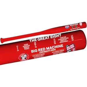 May include: A bright red baseball bat featuring white text that reads THE GREAT EIGHT and BIG RED MACHINE CINCINNATI REDS. It includes a list of player names, positions, and jersey numbers, along with 1975 and 1976 World Series details and logos.