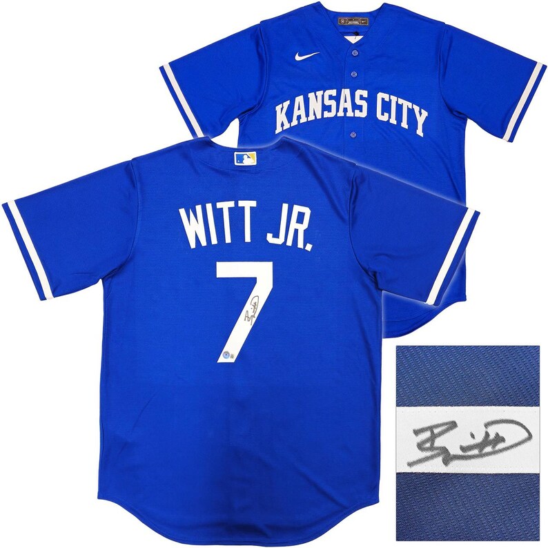 May include: Two royal blue baseball jerseys. One jersey has "KANSAS CITY" across the chest. The other jersey has "WITT JR." and the number "7" on the back. Both jerseys have white accents on the sleeves.