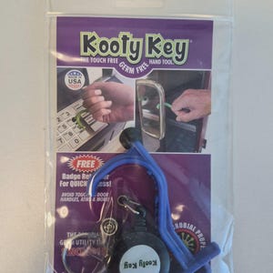 May include: A blue and black Kooty Key touch-free hand tool in a clear plastic package. The package has purple and white text, including "Kooty Key" and "Made in USA." The tool is designed to avoid touching door handles, ATMs, and more.