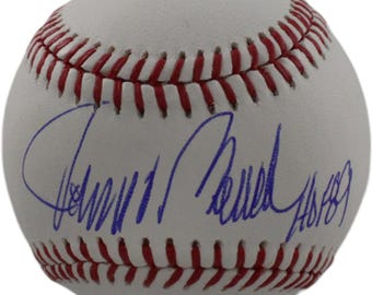May include: A white baseball with red stitching featuring a blue ink autograph across the center. The signature is written in cursive script and includes the inscription HO89, indicating a Hall of Fame induction year of 1989 on the leather surface.