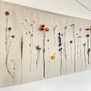 Wall hanging with dried flowers on a linen/cotton/polyester cloth