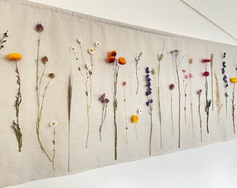Wall hanging with dried flowers on a linen/cotton/polyester cloth