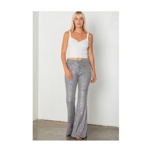 May include: Silver sequined flared pants with a high waist.