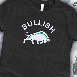 a black t-shirt with a graphic design of a bull and the word "Bullish" printed on it.
