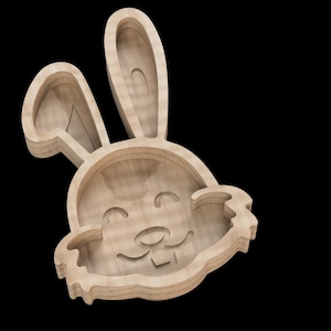 May include: A wooden bunny-shaped bowl with a smiling face. The bowl is made of natural wood and has a smooth finish.