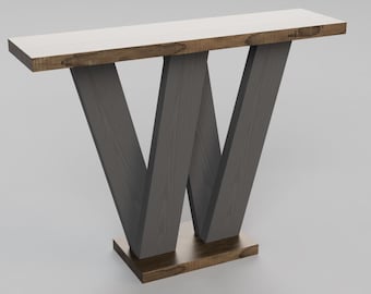 May include: A dark gray console table with a white top and a unique W-shaped base. The table has a brown wood trim around the top and base.