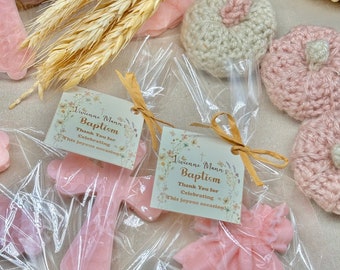 May include: Pink and white crocheted pumpkins, a pink cross and a pink dress, all wrapped in clear cellophane bags with a small tag that reads "Vivienne Mann's Baptism Thank You for Celebrating This Joyous Occasion!"