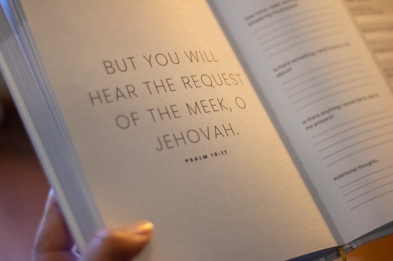 Puede incluir: Un libro abierto con fondo blanco y texto negro. El texto dice "BUT YOU WILL HEAR THE REQUEST OF THE MEEK, O JEHOVAH." y "PSALM 10:17".