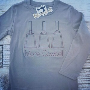 May include: A gray long-sleeve shirt with three cowbells embroidered on the front. The text "More Cowbell" is embroidered below the cowbells.