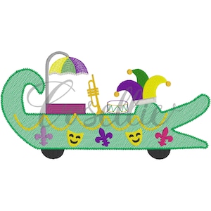 May include: A green alligator float with a purple and yellow umbrella, a gold trumpet, a drum, and a jester's hat. The float has a gold chain garland and purple fleur-de-lis and yellow smiling masks.