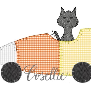 May include: A black cat driving a candy corn car with orange, white and yellow checked fabric. The car has two black wheels.