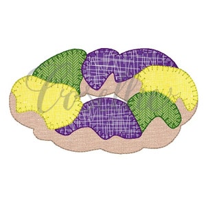 May include: A colorful patchwork design of a King Cake, a traditional pastry associated with Mardi Gras. The cake is decorated with purple, green, and gold fabric.