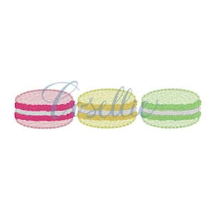 May include: Three macarons, one pink, one yellow, and one green, with white filling.