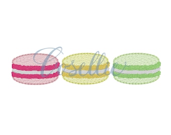 May include: Three macarons, one pink, one yellow, and one green, with white filling.