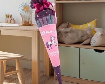 May include: A pink and purple school cone with a unicorn design. The cone has the name "Milana" and the text "Schulkind 2024" printed on it.