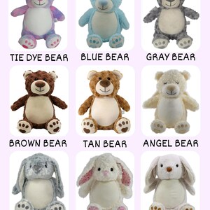May include: A collection of plush stuffed animals, including bears and bunnies. The bears come in various colors like tie-dye, blue, gray, brown, tan, and cream. The bunnies are gray, white with pink floral accents, and tan. Each animal has embroidered details and the name of the animal.