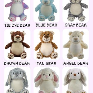May include: A collection of plush stuffed animals, including bears and bunnies. The bears come in various colors like tie-dye, blue, gray, brown, tan, and cream. The bunnies are gray, white with pink floral accents, and tan. Each animal has embroidered details and the name of the animal.