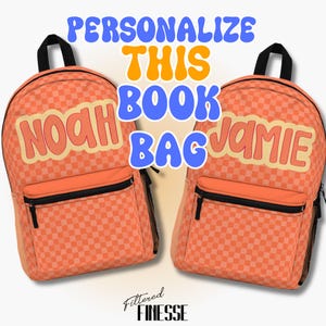 May include: Two orange checkered backpacks with black zippers and mesh side pockets. One backpack has the name "NOAH" and the other "JAMIE" in a retro font. The text "PERSONALIZE THIS BOOK BAG" is above the backpacks.