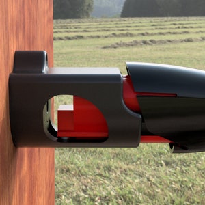May include: A black metal gate latch with a red release lever. The latch is mounted to a wooden post.