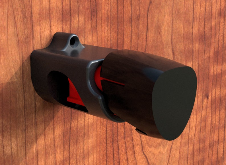 May include: A black plastic wall mount with a red accent, designed to hold a cylindrical object. The mount has a rounded, slightly angled end.