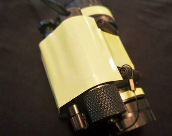 May include: A black flashlight with a bright green, textured, rubberized coating. The flashlight has a lanyard and a black, textured, knurled knob.
