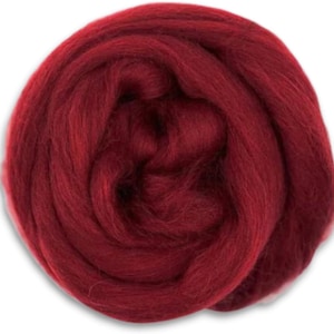 May include: A close-up of a deep red wool roving, a type of fiber used for felting and spinning.