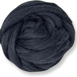 May include: A ball of dark gray wool roving, tightly wound and textured. The wool appears soft and fluffy, ideal for various fiber crafts like needle felting or wet felting. The color is a solid, deep charcoal.