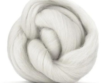 May include: A close-up of a white, fluffy ball of wool fiber. The wool is soft and appears to be spun into a yarn.