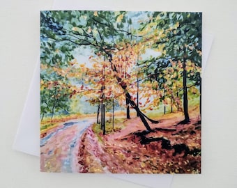 May include: A watercolor painting of a path winding through a forest with trees in shades of green, yellow, and orange. The ground is covered in fallen leaves.