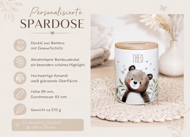 May include: A white ceramic money box with a glossy finish, featuring a brown bear illustration and the name THEO printed in black. It has a removable bamboo lid with a coin slot. The dimensions are 99 mm in height and 83 mm in diameter.