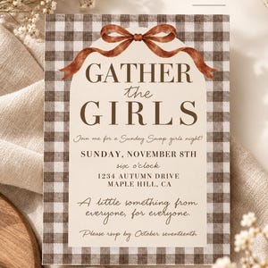 May include: A rectangular invitation card featuring a brown and white gingham border, a central cream-colored arch, and a brown watercolor ribbon graphic. The text reads: GATHER the GIRLS, Join me for a Sunday Swap girls night, SUNDAY, NOVEMBER 8TH, six o'clock, 1234 AUTUMN DRIVE, MAPLE HILL, CA, A little something from everyone, for everyone, Please rsvp by October seventeenth.