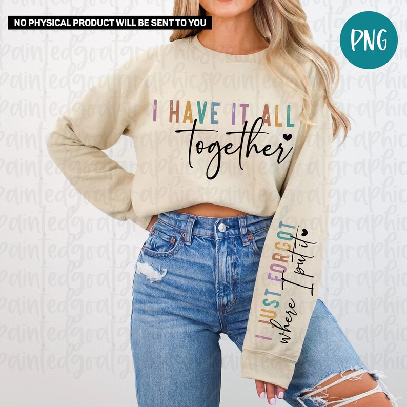 May include: A beige sweatshirt with long sleeves and the text "I HAVE IT ALL TOGETHER" printed on the front. The left sleeve has the text "I JUST FORGOT where I put it" printed on it in rainbow colors.