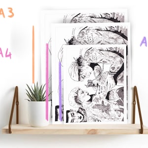 May include: Three black and white illustrations of people with tattoos, printed on white paper and framed with white borders. The illustrations are displayed on a wooden shelf with a small potted plant.