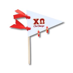 May include: A white triangular pennant with red ribbon streamers. The pennant has the letters XO and the words "Chi Omega" printed in red. Three red and gold hoop earrings are displayed on the pennant.