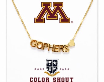 May include: A gold-toned necklace featuring the word GOPHERS in block letters and a small heart charm. The display card shows the University of Minnesota M logo, a shield emblem with a trophy, star, and owl, and the text COLOR SHOUT.