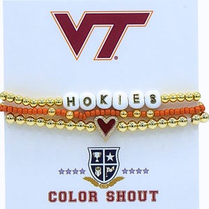 May include: Three-strand bracelet set with gold beads, orange beads, and white letter beads spelling "HOKIES." A red heart charm with a gold border is included. The background features the Virginia Tech logo and the words "COLOR SHOUT."