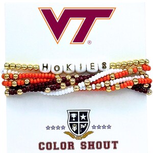 May include: Stack of beaded bracelets in maroon, orange, white, and gold. The word "HOKIES" is spelled out in white letter beads. The Virginia Tech logo and the words "COLOR SHOUT" are also visible.
