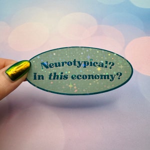 May include: A green oval sticker with a glittery finish and the text "Neurotypical? In this economy?" in black.