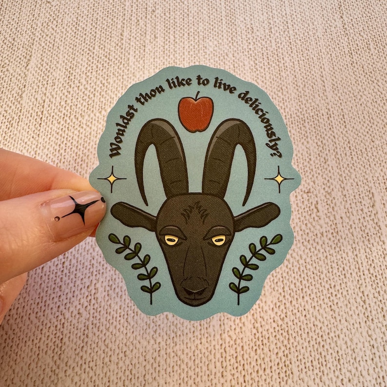 May include: A blue and white sticker with a black goat head and red apple. The text on the sticker reads "Wouldst thou like to live deliciously?"