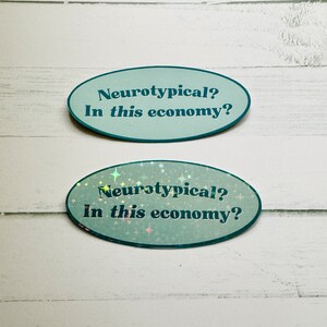 May include: Two oval stickers with a teal background and white text that reads "Neurotypical? In this economy?" The bottom sticker has a holographic finish with iridescent stars.