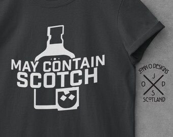 May include: A dark gray t-shirt with a white graphic of a bottle of scotch and the text "May Contain Scotch". The shirt has a crew neck and short sleeves. The John O' Designs logo is on the right sleeve.