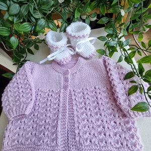 Handknitted baby jacket and booties