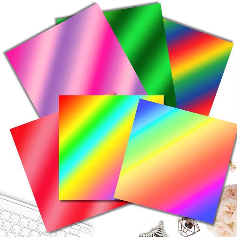 Puede incluir: Seis papeles con diferentes patrones de degradado en varios colores, incluyendo rosa, verde, rojo, azul, amarillo y naranja. Los papeles est&aacute;n dispuestos en forma de abanico.