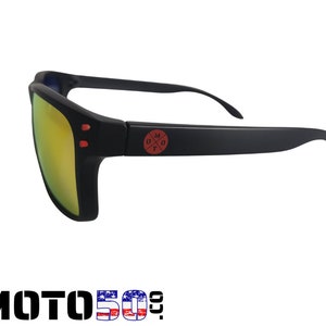 May include: Black sunglasses with a red logo that says "MOTO" with a cross inside the "O". The lenses are yellow.