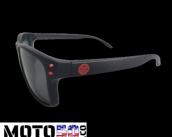 May include: Black sunglasses with red accents and a red logo that says "M0T0" with a cross inside the "O".